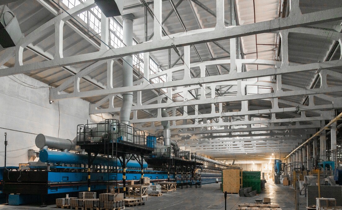 Cement factory interiors. Industrial cement production conveyor. Workers in the shop on the production line